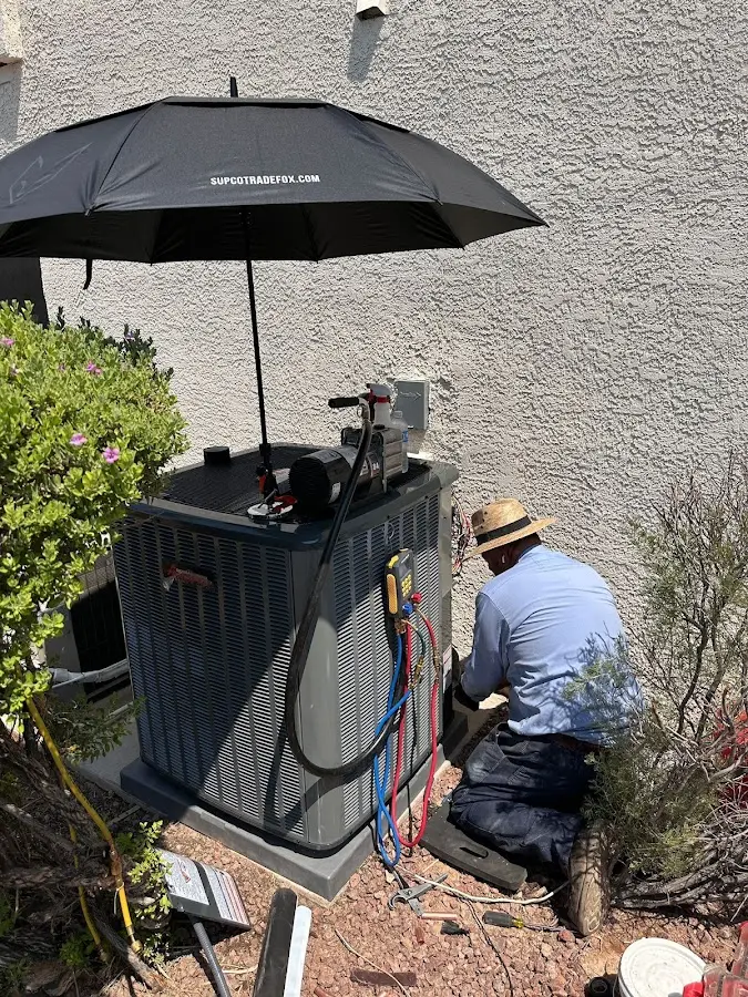 HVAC technician performing outdoor AC maintenance in Anadarko