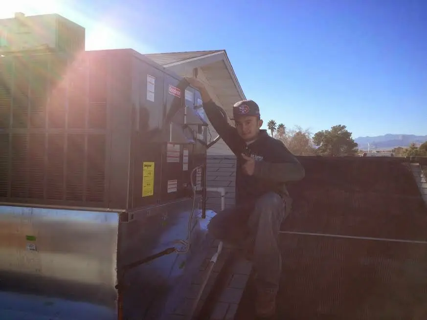 HVAC technician performing HVAC Inspection on a rooftop unit in Anadarko